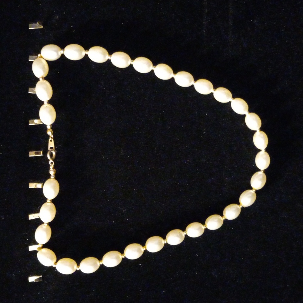 Faux pearl necklace with small gold tone beads between pearls